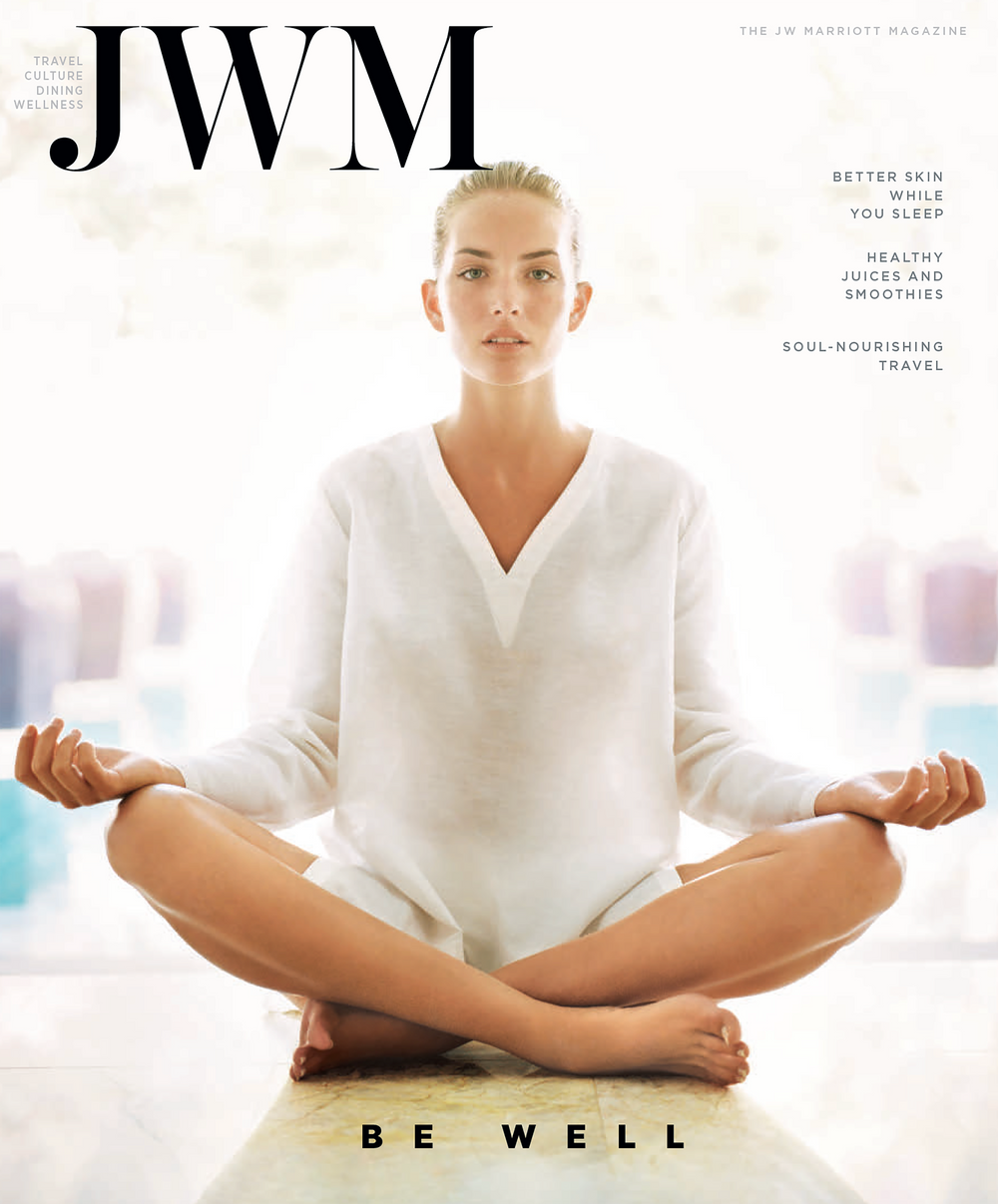 Cover of JWM Magazine of a model in white seated yoga pose 