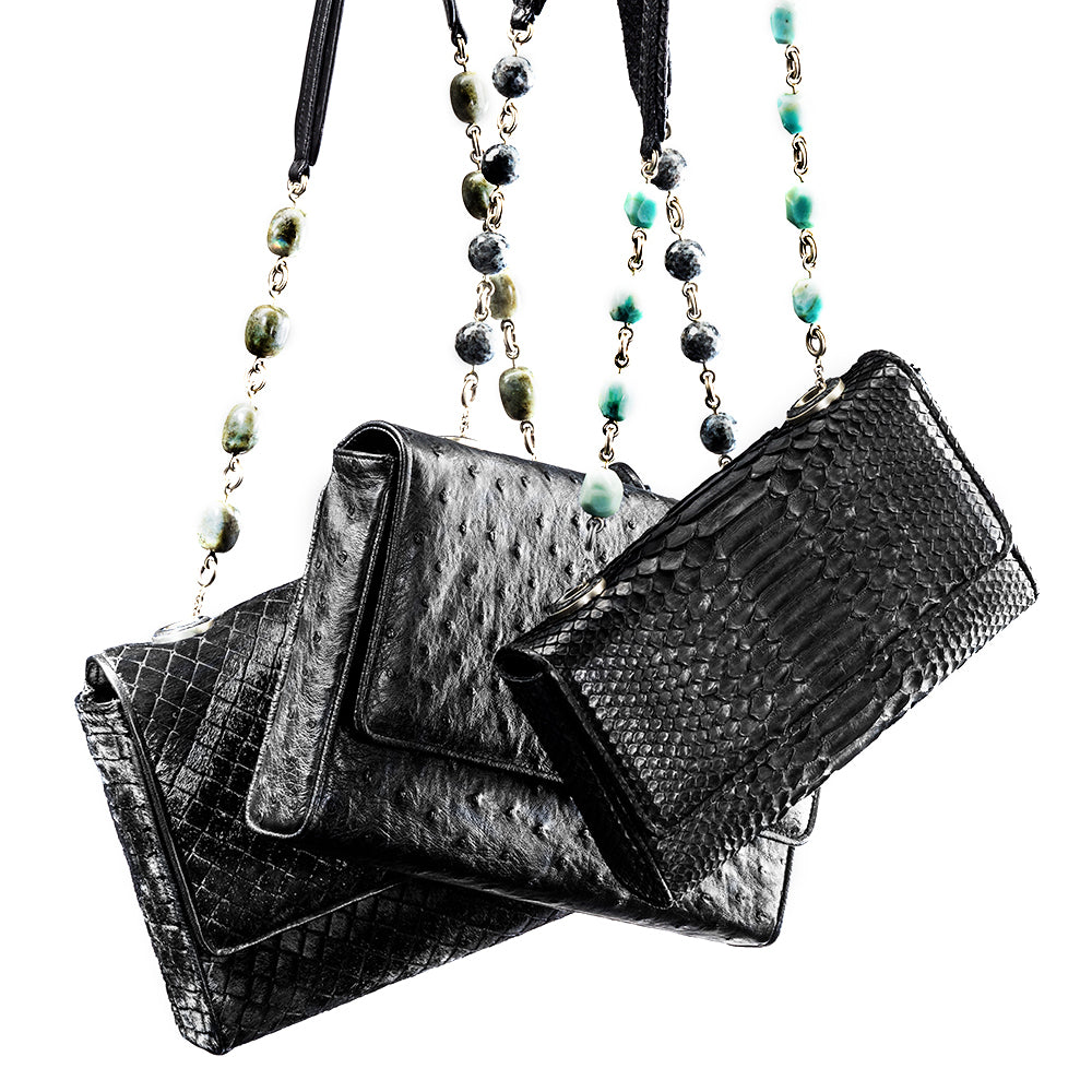 three black shoulder bags with beaded linked handles 