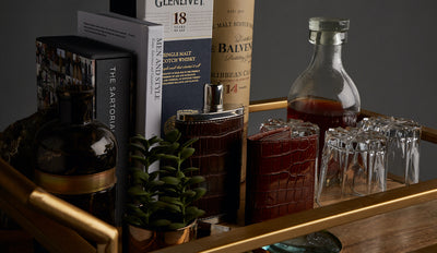 Bar cart with flask, wallet and glassware