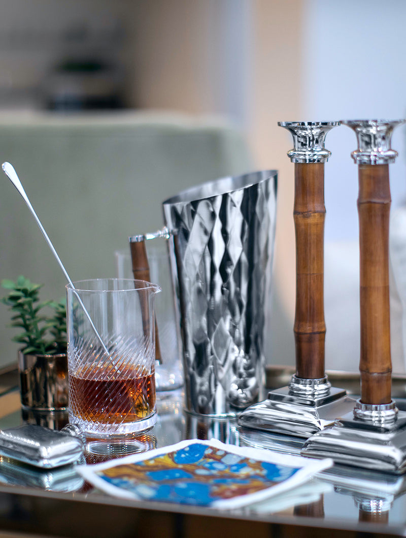 Glass, pitcher and candlesticks on bar cart - Darby Scott