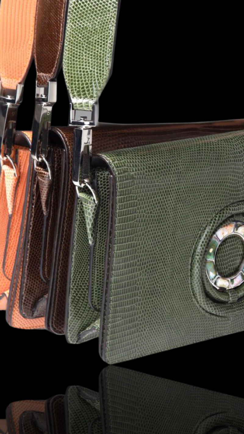 Green, Brown and Orange Lizard Anna Handbags Hanging in display - Darby Scott