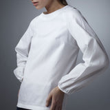 Model in White Cotton Long Sleeve Jewel Neck Blouse - Darby Scott