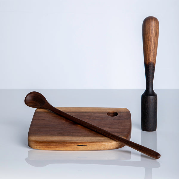 Cutting board with carved long spoon and muddler