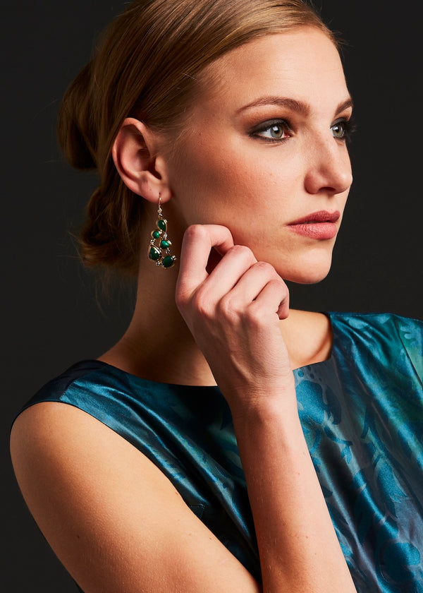 Model wearing Malachite 18K gold earrings by Darby Scott