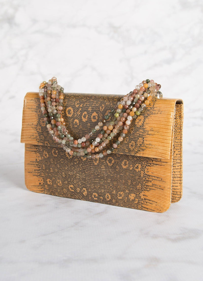 Angled view of Apricot Lizard Iconic Necklace Handbag - Darby Scott