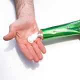 Large tube of shave cream and hand with cream