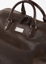 Close up of Sterling monogram plate Brown Aspen Travel Bag With Croc Trim - Darby Scott