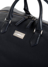 Close Up of Sterling Silver Monogram Plate on Aspen Travel Bag - Darby Scott